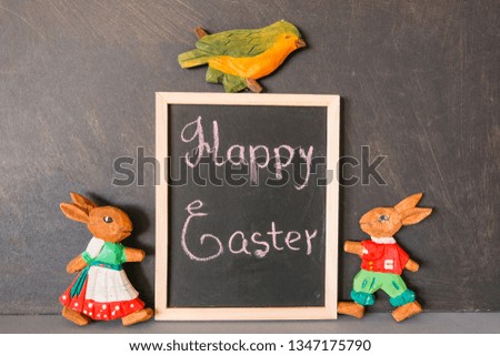 Easter picture with bunnies, a bird and a sign with the inscription. Decorative concept