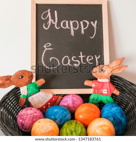 Easter picture with painted eggs in a basket and a sign with the inscription. Decorative concept