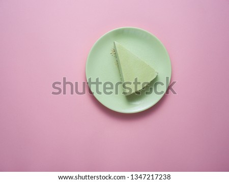 Green tea cheesecake on a green plate.