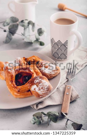 Homemade puff pastry with cherry and apple. Sweet tasty dessert with cup of coffe with milk. Hugge scandinavian style. Toned picture.