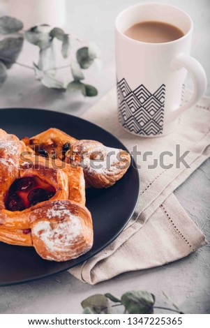Homemade puff pastry with cherry and apple. Sweet tasty dessert with cup of coffe with milk. Hugge scandinavian style. Toned picture.