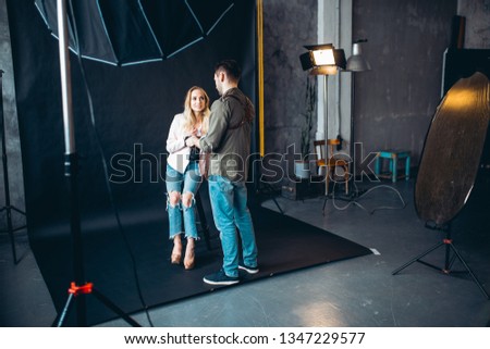 photographer showing his sympathy to a lovely girl, man and woman having a rest after taking photos, break time