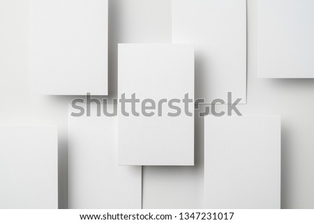 Design concept - top view of vertical business card isolated on white background for mockup, it's real photo, not 3D render