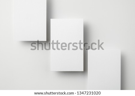 Design concept - top view of 3 vertical business card isolated on white background for mockup, it's real photo, not 3D render