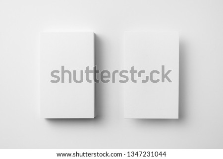 Design concept - top view of 2 vertical business card isolated on white background for mockup, it's real photo, not 3D render