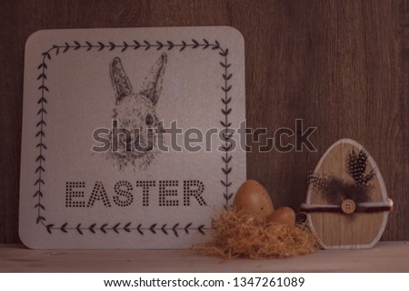 Happy Easter. Easter Bunny. Easter eggs and wooden decoration.
