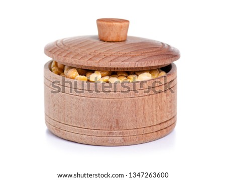 Peas in wooden bowl with lid on white background isolation