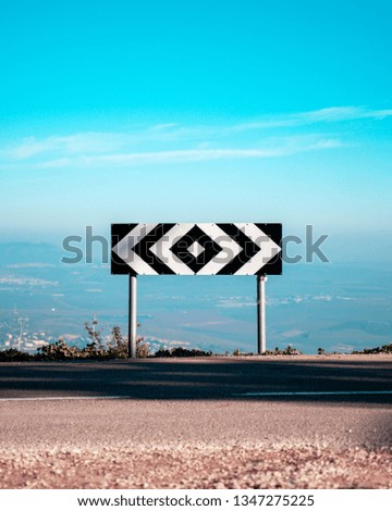 road sign in the middle of a crossroad