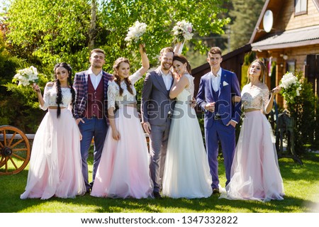 big merry wedding is photographed against the backdrop of a green summer garden