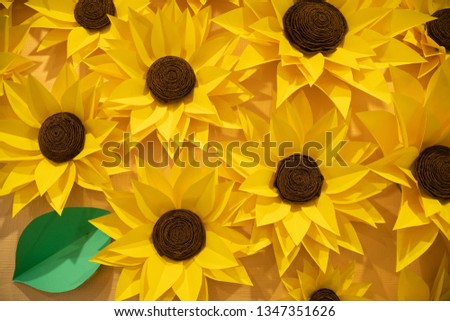 beautiful handmade origami paper sunflowers on the wall. many yellow beautiful flowers.