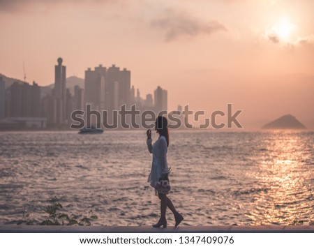 Girl walking along the coast of Victoria Harbour, Hong Kong at Hong Kong. 