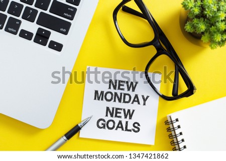New Monday New Goals Concept on office desktop top view with office supplies.
