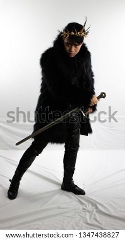 Evil king in black coat with sword