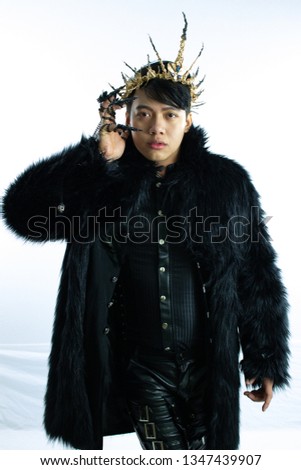 Evil king in black fur coat