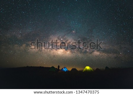 Blue dark  night sky with with star Milky way Space background and silhouette of a standing happy man