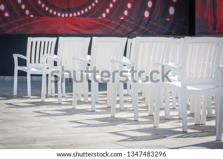 White simple chairs with back in summer theater for viewing performances on stage