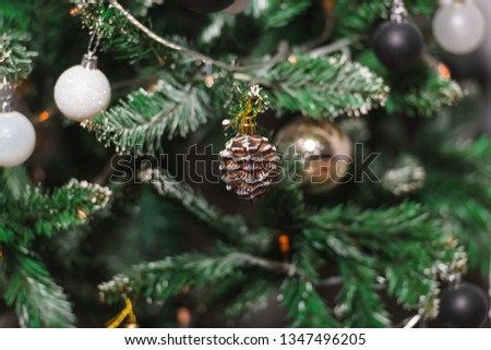 Christmas decoration in gold, black and white colors. Black and white christmas tree. Modern New Year's scenery. Black and white frosted balls.