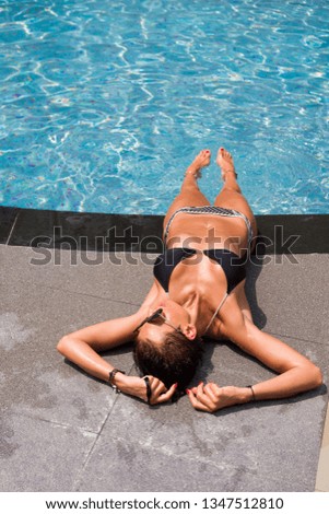 woman in luxury five stars  spa resort in the swimming pool. - UNRETOUCHED body.