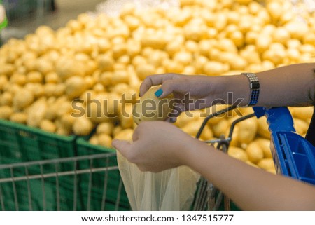 Woman holding Potato and shopping in department store