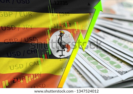 Uganda flag and chart growing US dollar position with a fan of dollar bills