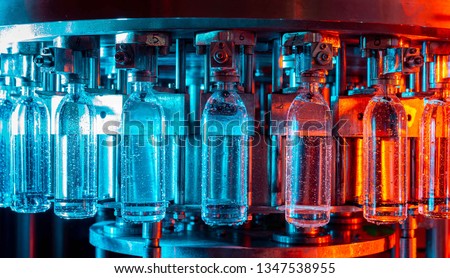 Water bottling line for processing and bottling pure spring water Royalty-Free Stock Photo #1347538955