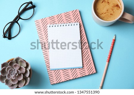 Flat lay composition with notebooks, coffee and plant on color background