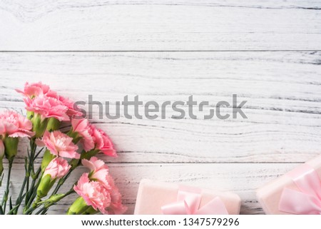 Design concept - top view of bunch of beautiful carnation on white vintage wooden background for mothers day, wedding and valentines day with copy space for mock up