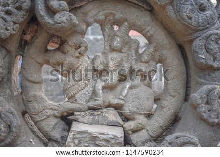 Picture of a ancient ruined stone carving of Hindu god in the old city of India