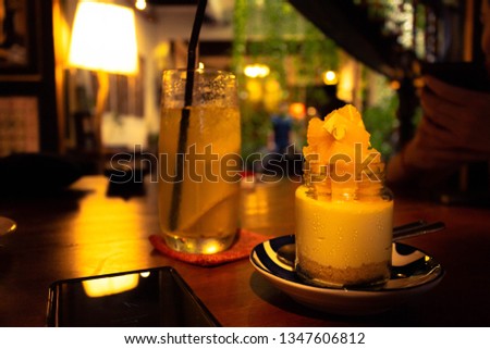 Picture of An Orange Cheesecake with A glass of Lime Juice as complement