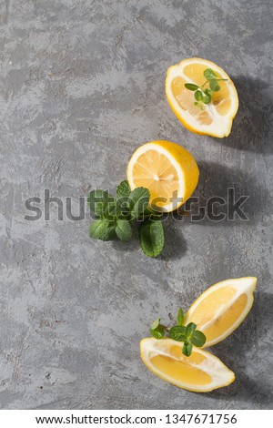 Composition with lemon and mint on grey background