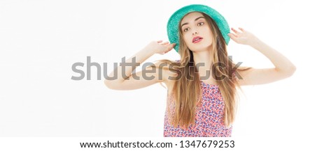 Young beautiful blonde with perfect skin in summer hat posing on white background