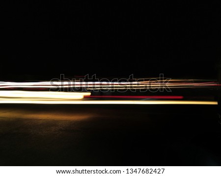 Blurred images from the light from a car that runs at the speed of the road at night