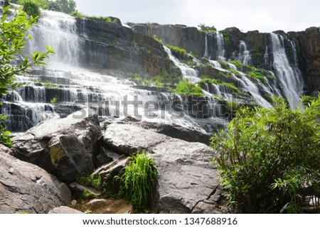 7 layers of waterfall with rock and white water streaming green trees spring creek in Da Lat Vietnam Thac Bay Tang 