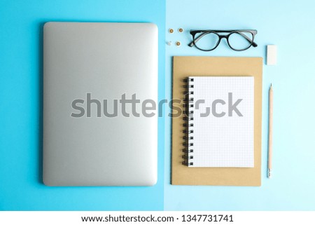 Flat lay composition with office accessories on two tone background, space for text