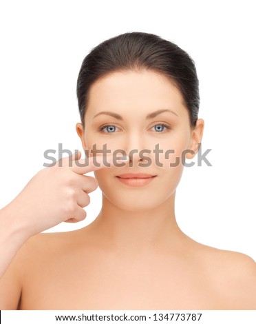 face of beautiful woman touching her nose Royalty-Free Stock Photo #134773787