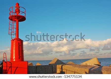 Red lighthouse at sunset. Adriatic Sea, Italy