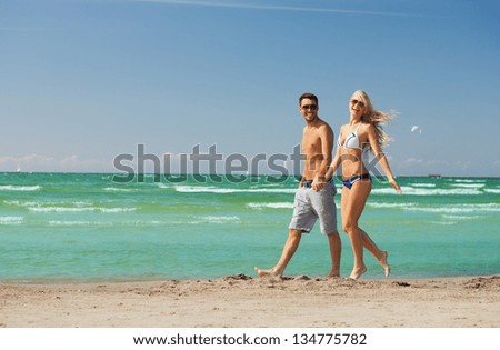 picture of happy couple walking on the beach.