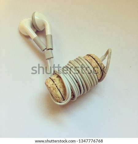 Wine cork ear buds headphone holder on white background.  Great for music lovers for their mobile device.