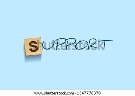 Support. Words written on a wooden block. Blue Background Isolated. Idea of advice, help, and assistance. Business concept.