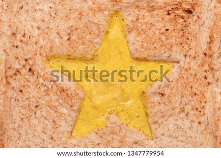 The texture of the surface of a fried sandwich with an omelette star. Close-up