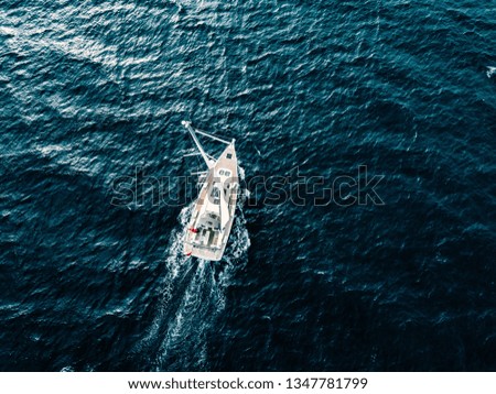 Aerial view of Sailing ship yachts with white sails in windy condition in deep blue sea