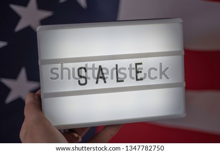 Lightbox with lettering Sale on Flag of USA. Online shopping concept. 