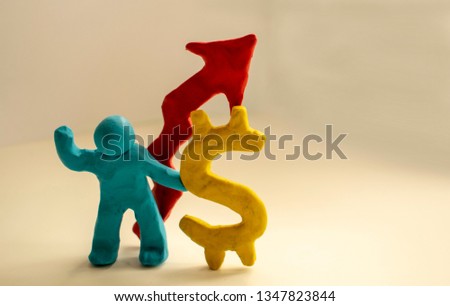 The plasticine man holds a dollar and is proud of it.
