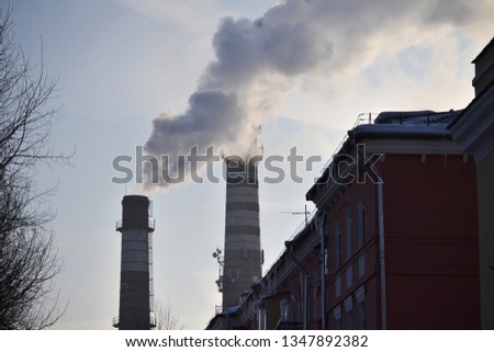 Two pipes. Industrial smoke from a chimney against the sky