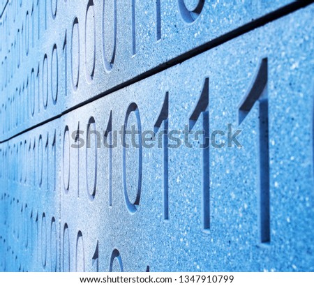 stone wall showing binary code, 1,0, ones and zeros