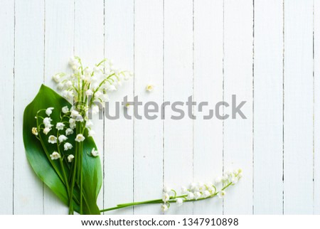 convallaria flowers on white wood table, wedding background