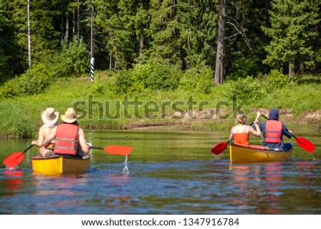 Two canoes approaching country border.