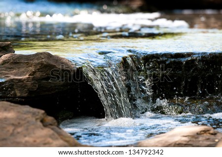Up-close view of stream waterfall Royalty-Free Stock Photo #134792342