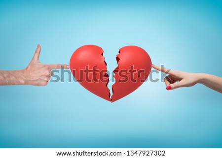 Male and female hands holding red broken heart on light blue background. Digital art. People and objects. Love and separation.