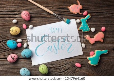 Easter gingerbread cookies on wooden table. Rabbits and eggs. Greeting card. Top view with space for your greetings.